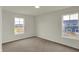 Light-filled bedroom with neutral walls and carpet, showcasing the window view at 5777 Greenbrier Ct, Brownsburg, IN 46112