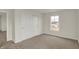 Bedroom with neutral walls and carpeted floors, featuring a double door closet and window at 5777 Greenbrier Ct, Brownsburg, IN 46112