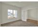 Bright bedroom featuring neutral walls, carpeted floors, and a large window overlooking the neighborhood at 5777 Greenbrier Ct, Brownsburg, IN 46112