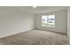 Bedroom features neutral walls, carpeting, and windows offering views of the surrounding neighborhood at 5777 Greenbrier Ct, Brownsburg, IN 46112