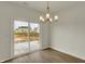 Bright dining area featuring a sliding door and modern chandelier lighting fixture at 5777 Greenbrier Ct, Brownsburg, IN 46112