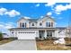 Beautiful two-story home with gray siding, front lawn, and a two car garage at 5777 Greenbrier Ct, Brownsburg, IN 46112