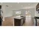 Contemporary kitchen with a central island, modern fixtures, stainless appliances, and wood-look floors at 5777 Greenbrier Ct, Brownsburg, IN 46112