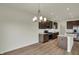 Modern kitchen featuring stainless steel appliances, island, and brown cabinetry at 5777 Greenbrier Ct, Brownsburg, IN 46112