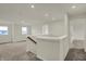 Upstairs loft area with neutral walls and carpeting with windows offering views of the surrounding area at 5777 Greenbrier Ct, Brownsburg, IN 46112