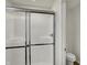 Modern bathroom shower with sleek glass doors and updated fixtures plus a toilet to the right at 5777 Greenbrier Ct, Brownsburg, IN 46112
