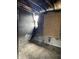 View of fire damaged bedroom, with burned walls and boarded up window at 6009 Tammin Dr, Indianapolis, IN 46254