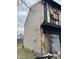 This house shows exterior fire damage, in need of significant repair and restoration; buyer must assume risk at 6009 Tammin Dr, Indianapolis, IN 46254