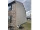 Home's exterior shows brick and vinyl siding, needs repair from previous fire, but good location at 6009 Tammin Dr, Indianapolis, IN 46254
