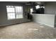 View of damaged living room with holes in wall, damage to the ceiling, and water damage throughout at 6009 Tammin Dr, Indianapolis, IN 46254