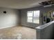 Damaged living room with exposed wall, damaged floors, and water stained walls at 6009 Tammin Dr, Indianapolis, IN 46254