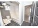 Modern bathroom featuring a soaking tub, stylish sink, and contrasting gray and white color scheme at 615 E Morris St, Indianapolis, IN 46203