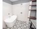 Bright bathroom features tiled shower, tub, and built-in shelving at 615 E Morris St, Indianapolis, IN 46203