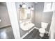 Well-lit bathroom with a vintage sink, modern fixtures, and gray accent wall at 615 E Morris St, Indianapolis, IN 46203