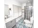 Bright bathroom featuring a glass enclosed shower, modern vanity, and eye-catching tile flooring at 615 E Morris St, Indianapolis, IN 46203