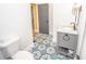 Modern bathroom boasts patterned tile, a sleek vanity, and stylish fixtures at 615 E Morris St, Indianapolis, IN 46203