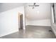 Large bedroom has vaulted ceilings, a ceiling fan, gray wood floors, and an open doorway at 615 E Morris St, Indianapolis, IN 46203