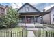 Charming home featuring a welcoming front porch and nicely landscaped yard at 615 E Morris St, Indianapolis, IN 46203
