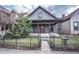 Charming home featuring a welcoming front porch and nicely landscaped yard at 615 E Morris St, Indianapolis, IN 46203