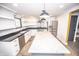 This open kitchen has stainless steel appliances, a stylish backsplash, and an island at 615 E Morris St, Indianapolis, IN 46203