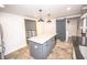 The modern kitchen island features a marble countertop and sleek gray cabinetry at 615 E Morris St, Indianapolis, IN 46203