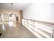 Open-concept living room with hardwood floors, a decorative light fixture, and a wall of built-in shelving at 615 E Morris St, Indianapolis, IN 46203