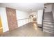 Well-lit living room boasts exposed brick, hardwood floors, and built-in shelves at 615 E Morris St, Indianapolis, IN 46203