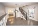 The open living space features hardwood floors, stairs, and a view of the kitchen at 615 E Morris St, Indianapolis, IN 46203
