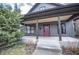 Charming home featuring a welcoming front porch and nicely landscaped yard at 615 E Morris St, Indianapolis, IN 46203