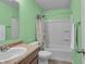 Bright bathroom features green walls, a shower-tub combo, and a marble-look vanity at 6180 N Rosewood Dr, McCordsville, IN 46055