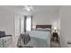 Well-lit bedroom with neutral walls, soft carpet, and a cozy bed with decorative pillows at 6180 N Rosewood Dr, McCordsville, IN 46055