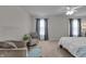 Spacious bedroom featuring neutral walls, soft carpet, and two comfortable chairs with accent pillows at 6180 N Rosewood Dr, McCordsville, IN 46055