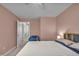 Bright bedroom featuring pink walls, a soft carpet, and a comfortable bed with decorative pillows at 6180 N Rosewood Dr, McCordsville, IN 46055