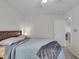 Comfortable bedroom featuring neutral walls, soft carpet, and a cozy bed with a gray throw blanket at 6180 N Rosewood Dr, McCordsville, IN 46055
