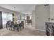 Dining area with a wooden table, seating for six, and view to the kitchen at 6180 N Rosewood Dr, McCordsville, IN 46055