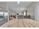 Open-concept dining room leading into living room with stainless refrigerator at 6180 N Rosewood Dr, McCordsville, IN 46055