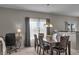 Dining area with a wooden table, seating for six, and natural light at 6180 N Rosewood Dr, McCordsville, IN 46055