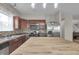 Well-lit kitchen with stainless steel appliances, brown cabinetry, and wood table at 6180 N Rosewood Dr, McCordsville, IN 46055