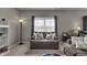 Cozy living room with a comfortable loveseat, throw pillows, and ample natural light at 6180 N Rosewood Dr, McCordsville, IN 46055