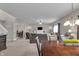 Open-concept living room with ceiling fan and adjacent dining area at 6180 N Rosewood Dr, McCordsville, IN 46055
