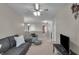 Comfortable living room with neutral walls, soft carpet, and a gray sofa with decorative pillows at 6180 N Rosewood Dr, McCordsville, IN 46055