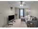 Cozy living room with neutral walls, soft carpet, and a comfortable gray sofa with decorative pillows at 6180 N Rosewood Dr, McCordsville, IN 46055