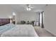 Bright main bedroom with a ceiling fan, bedside lamps, and neutral decor at 6180 N Rosewood Dr, McCordsville, IN 46055