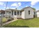 A quaint home featuring a small, fenced backyard and a charming sunroom addition at 633 Fletcher Ln, Beech Grove, IN 46107