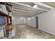 Unfinished basement space with open ceiling and shelving at 633 Fletcher Ln, Beech Grove, IN 46107