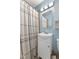 Bathroom featuring a shower/tub combo, vanity with sink, mirrored medicine cabinet, and light blue walls at 633 Fletcher Ln, Beech Grove, IN 46107