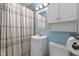 Light blue bathroom featuring a shower/tub combo, vanity with sink, and mirrored medicine cabinet at 633 Fletcher Ln, Beech Grove, IN 46107