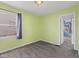 Bedroom showcasing green walls, neutral carpeting, a window with blinds, and a doorway at 633 Fletcher Ln, Beech Grove, IN 46107
