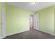 Bedroom with green walls, neutral carpeting, and a doorway leading to another room at 633 Fletcher Ln, Beech Grove, IN 46107