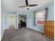 Light blue bedroom with closet, carpet, and wooden dresser at 633 Fletcher Ln, Beech Grove, IN 46107